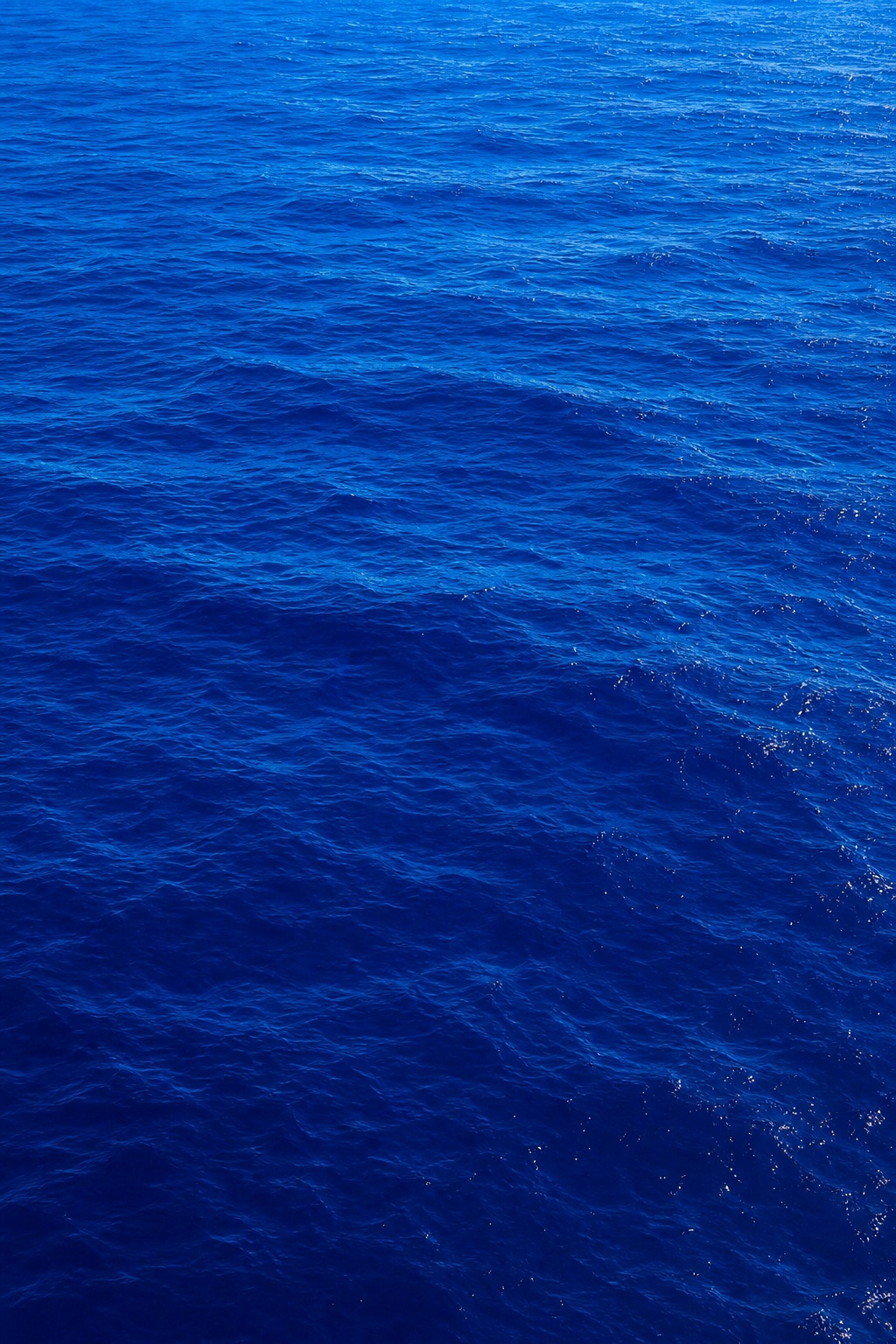 Deep blue ocean water with rippled surface texture