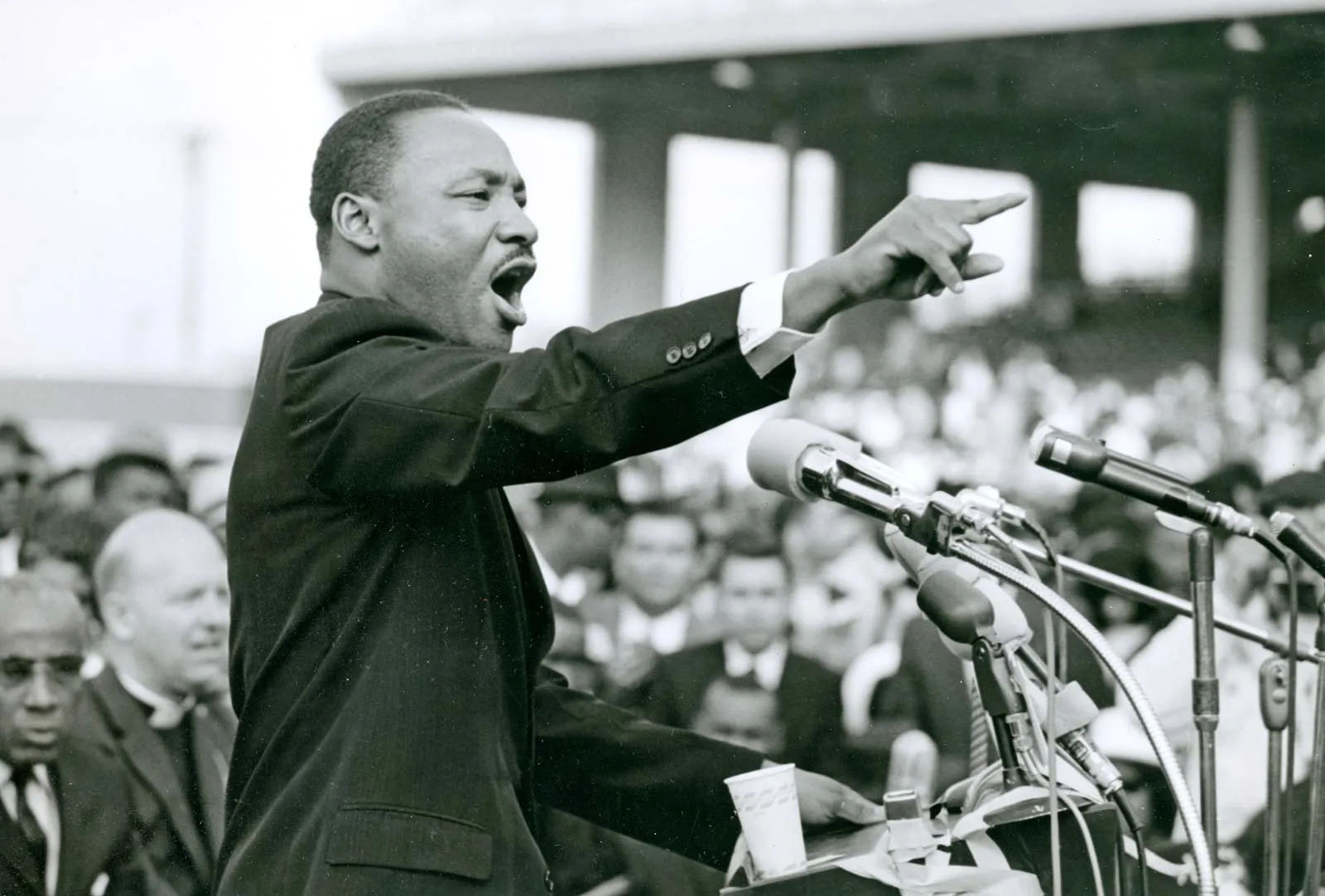 Martin Luther King Jr. speaking passionately to a crowd at a podium.