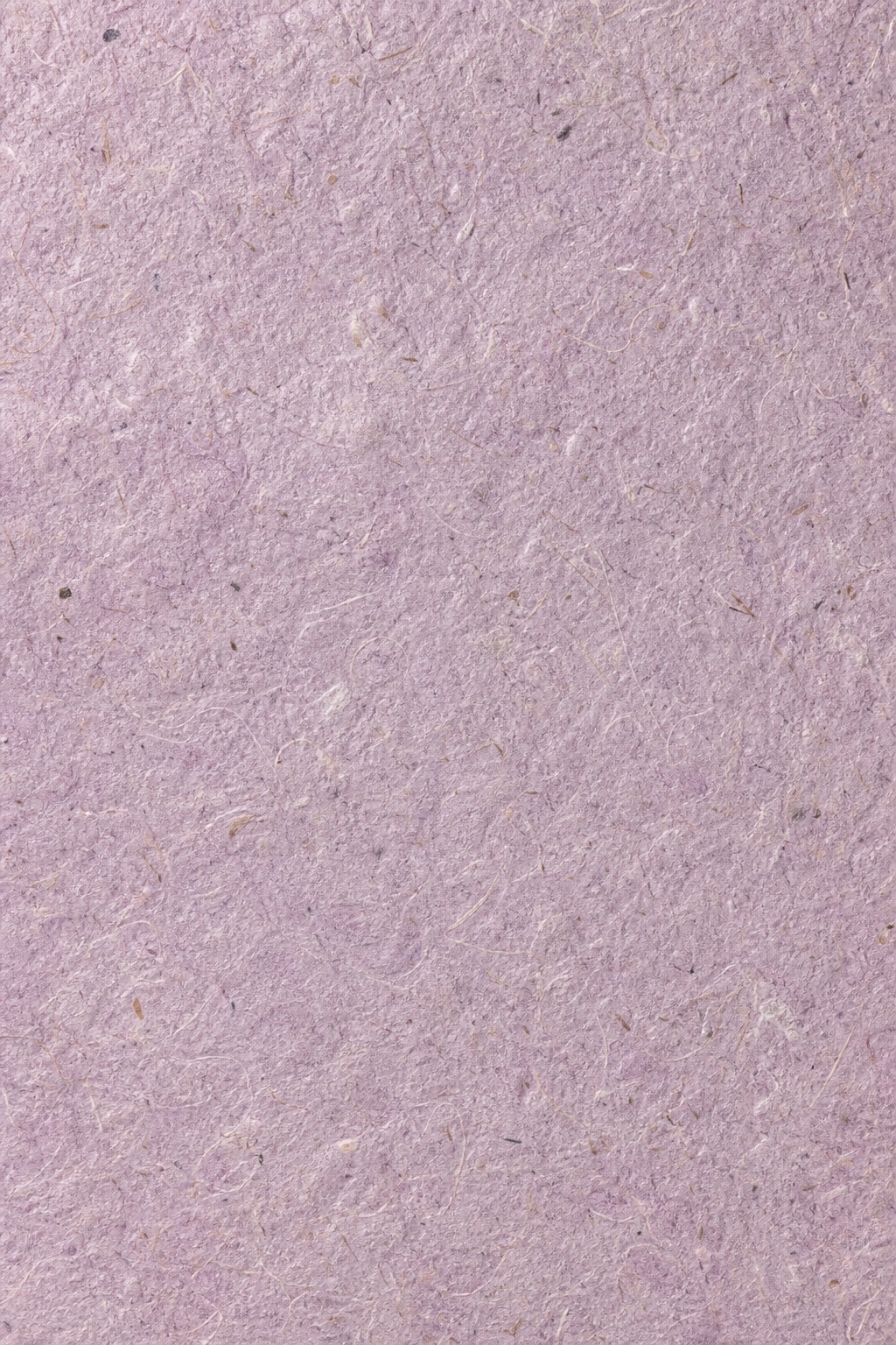 Soft rose lilac handmade paper texture with fine speckled plant fibers.
