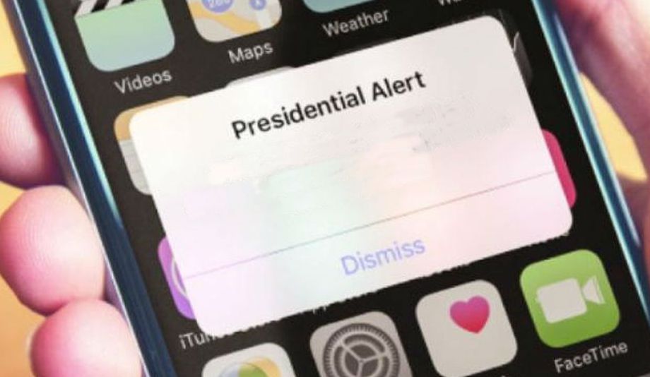 Smartphone screen showing a presidential alert notification over app icons