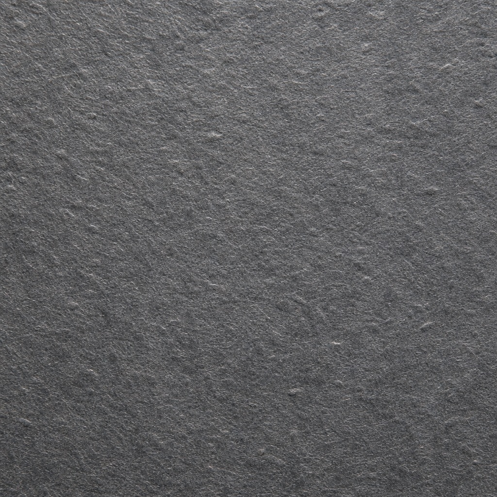 Dark gray textured paper surface with fine grain and subtle fiber details