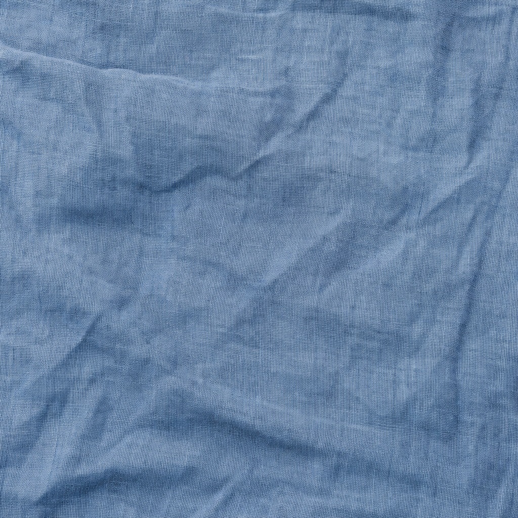 Blue linen fabric texture with soft woven folds and subtle wrinkles