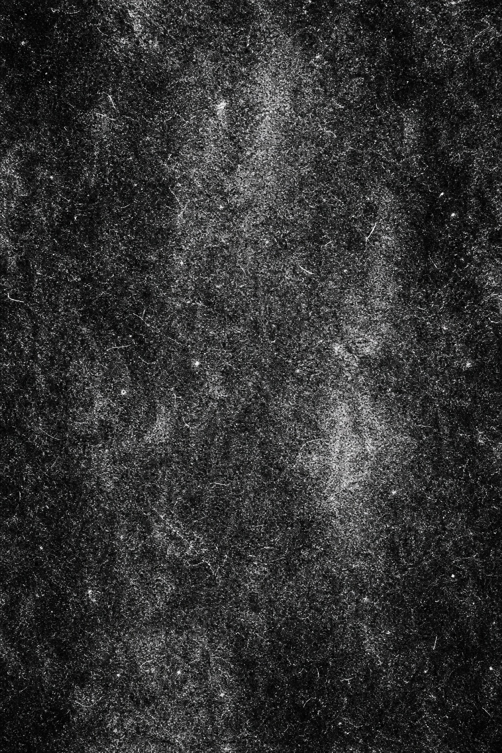 Dark high-contrast charcoal texture with scattered paper fiber grain