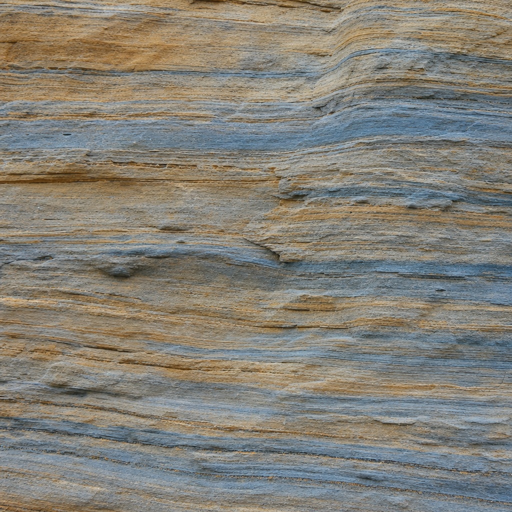 Layered blue-gray sandstone with thin horizontal sediment bands and textured stone surface