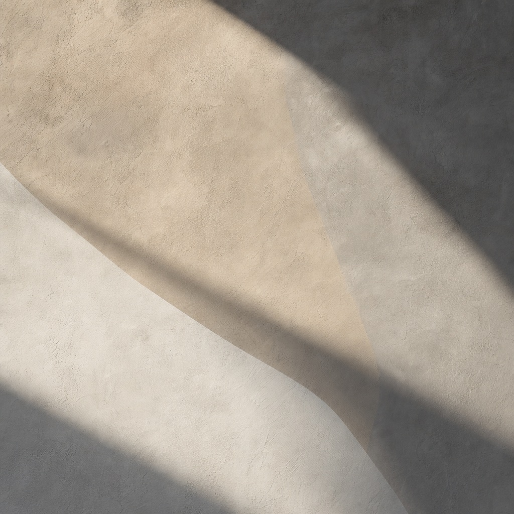 Soft beige plaster surface with sweeping diagonal shadows and subtle texture.