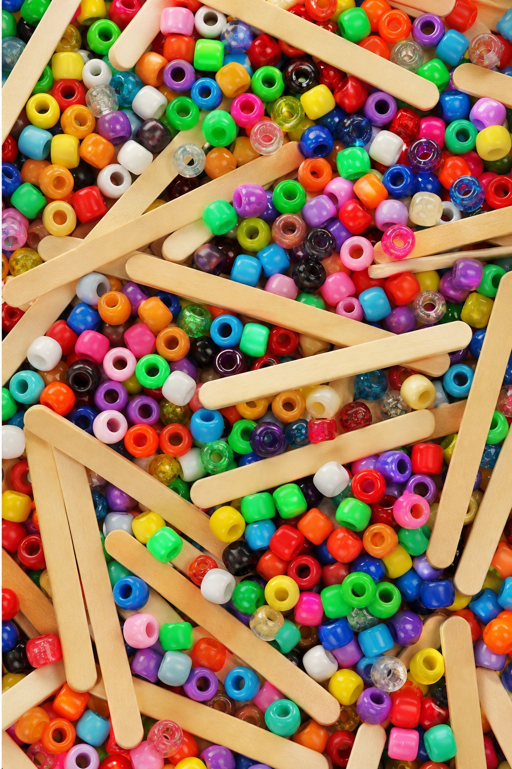 Colorful craft beads scattered behind overlapping wooden popsicle sticks in a vertical layout.