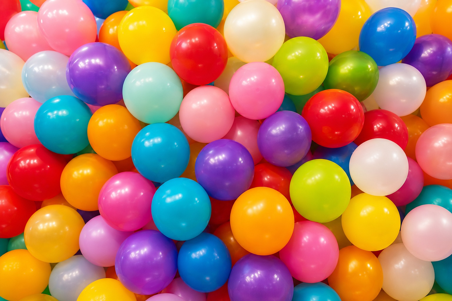 Colorful balloons packed together in a bright birthday party background