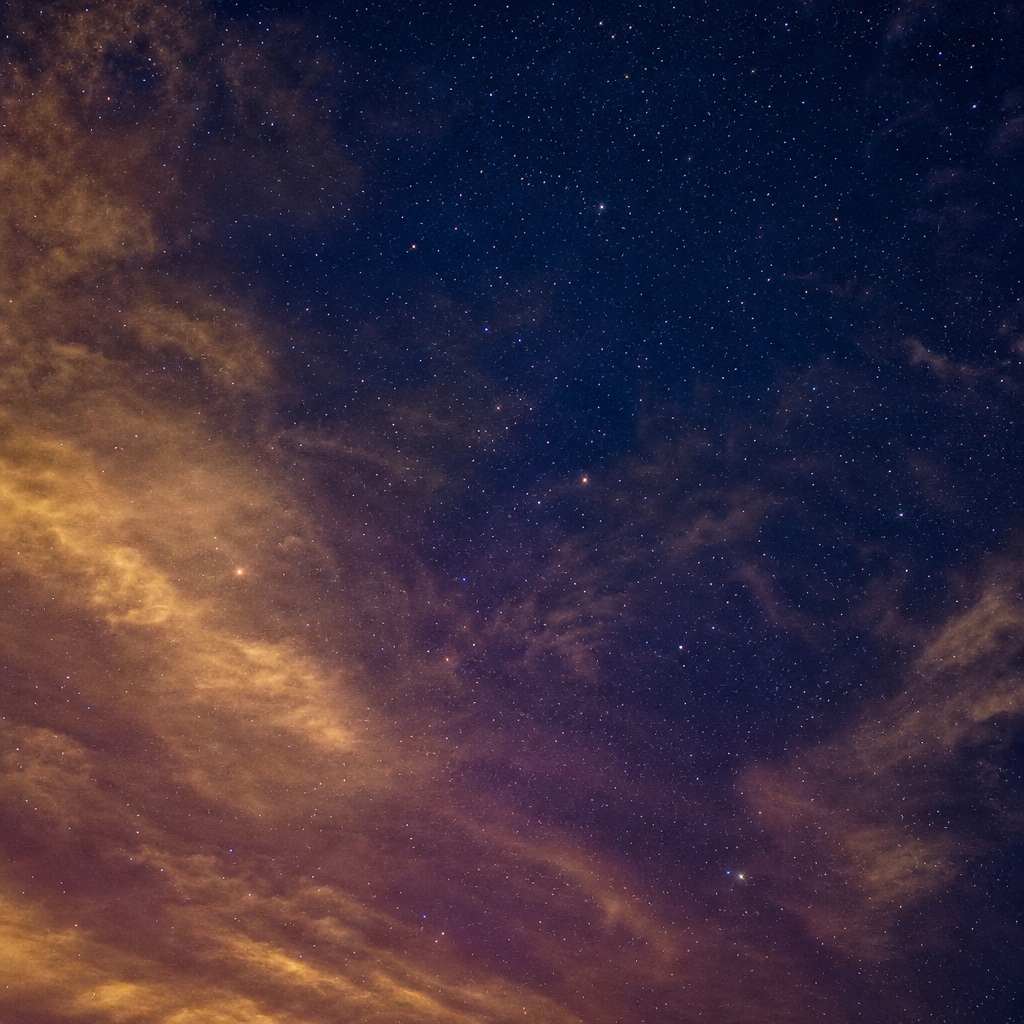 Gold and indigo clouded star field with wispy night sky clouds