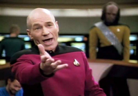 Captain Jean-Luc Picard gesturing in a red uniform