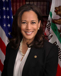 Kamala Harris standing in front of the American and Californian flags