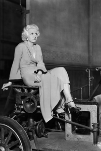 Marilyn Monroe sitting on old machinery in a black and white photograph
