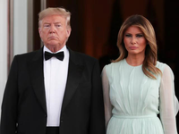 Donald Trump and Melania Trump standing together in formal attire