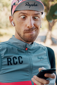 Man in Rapha cycling gear looking at phone