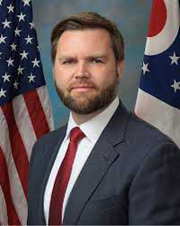 Man in suit standing in front of American and Ohio flags