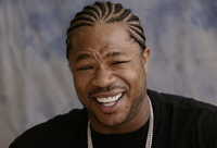 Tracy Morgan smiling with braided hair