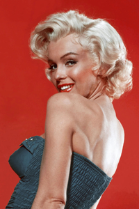Marilyn Monroe in a strapless dress against a red background