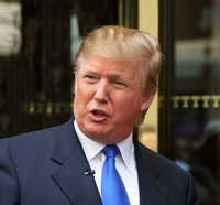 Donald Trump speaking in a suit