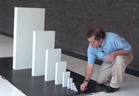 Man arranging white blocks in descending order