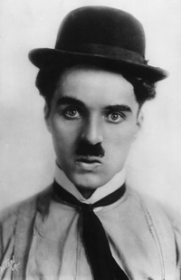 Black and white portrait of Charlie Chaplin wearing a bowler hat and a serious expression
