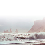 A peaceful beach with waves and rocky outcrops