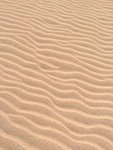 Close-up view of sand dunes with rippled texture