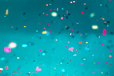 Colorful confetti scattered on a teal background