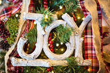 Christmas decoration with wooden 'JOY' sign