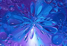 Blue liquid droplets forming a flower-like pattern