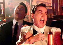 Two men in suits laughing