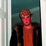 Man in a fur coat and bandana standing in a doorway with red lighting