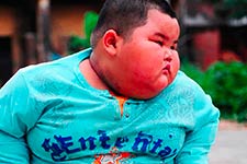 A boy with a swollen face wearing a blue Entre Rites shirt