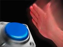 Hand poised to press a large blue button
