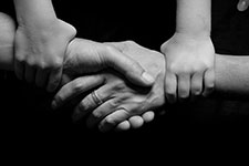 Hands clasped together in a gesture of unity and support