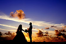 Silhouette of a couple holding hands at sunset